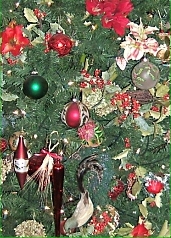 This detail of the tree shown above shows cut flowers, holly branches, blown glass ornamants, and other decorations that were popular a century ago. Click for a bigger picture.