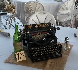 Here's a vintage typewriter being used as a decoration on a wedding reception table.  What WILL they think of next.  Click for bigger photo.