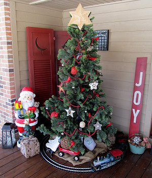 The 'outdoor' Christmas tree display in a corner of the Race family's covered porch, December, 2017.  Click for bigger photo.