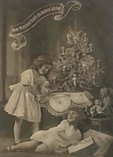 The classic German Christmas tree, as shown in this early 1900s postcard, was a small fir or spruce with relatively sparse decorations and lit candles. Don't try this at home. Click for a larger photo.